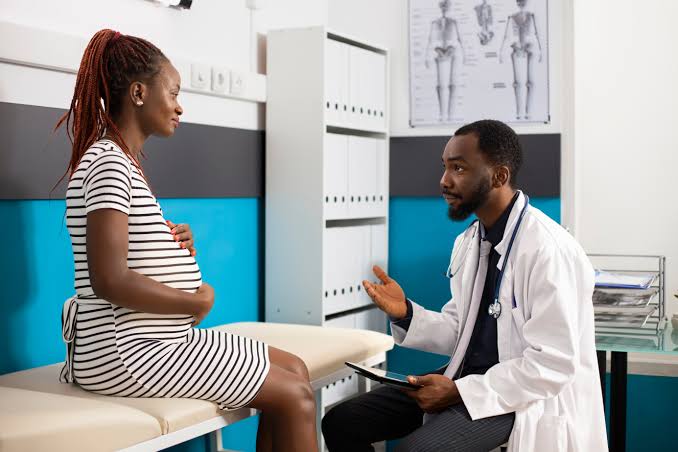Pregnant woman talking with a doctor during a consultation