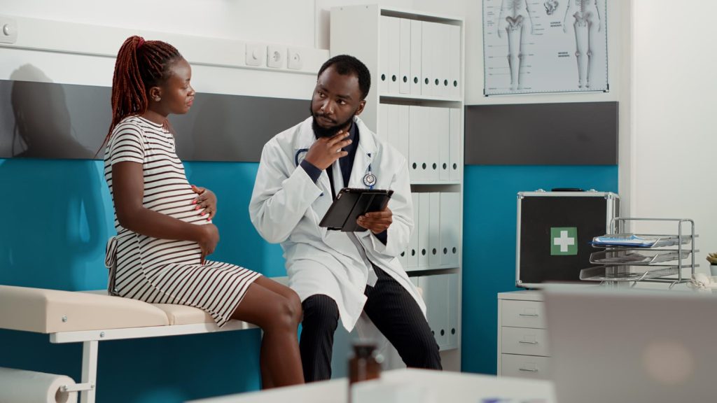 Doctor consulting a woman in a gynaecology clinic room